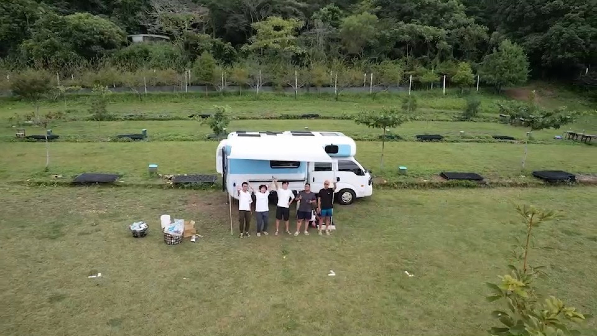 Five travelers happy group photo on Kenting grass with campervan