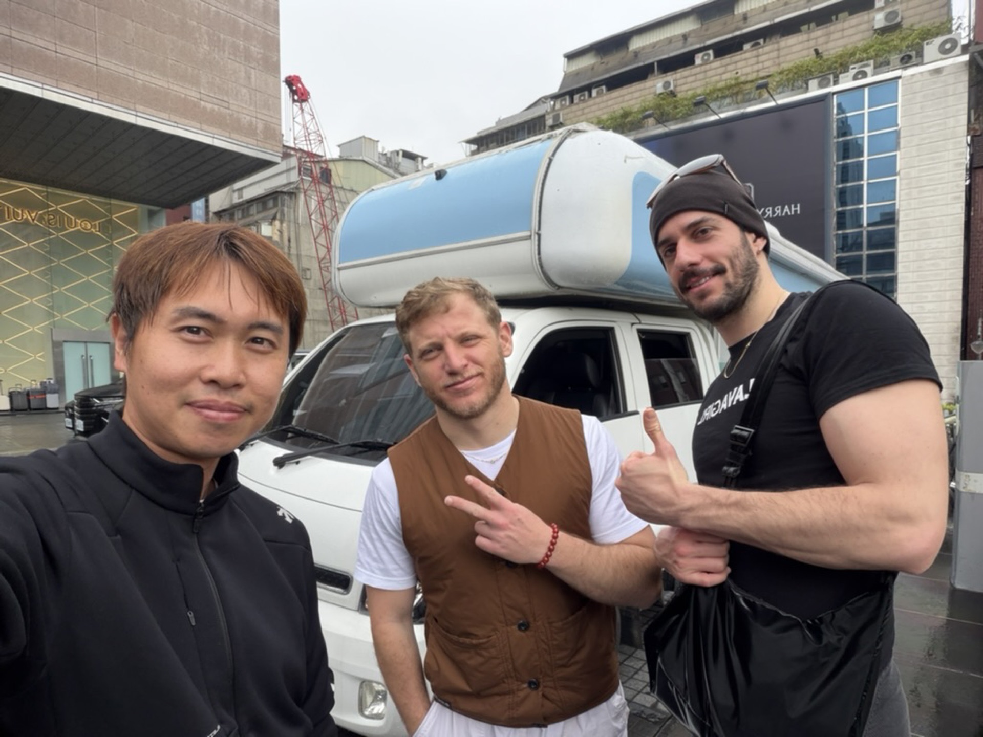 International travelers group photo with campervan at Taipei street handover
